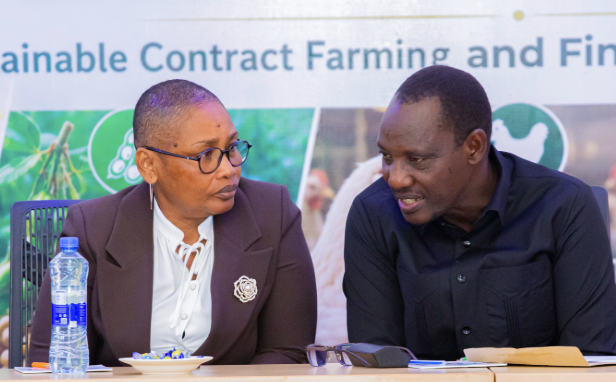 Ambassador Dr. Bashiru Ally Kakurwa in conversation with Ms. Elizabeth Swai during the Contract Farming Stakeholder Dialogue, Dodoma, May 22, 2026
