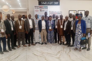 Group of delegates standing together in the lobby of Sawela Lodges at the 13th World Potato Congress in Naivasha, Kenya, beside WPC 2026 Kenya banners.